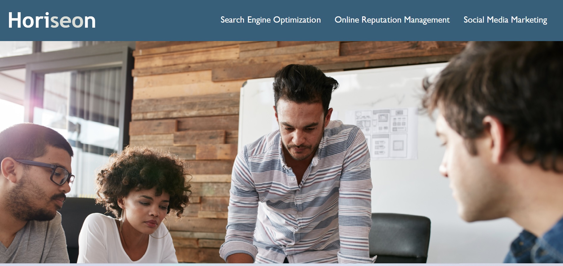 A screen shot of the website Horiseon. It displays the page's name, navigation bar, and an image of a group of coworkers working collaboratively.